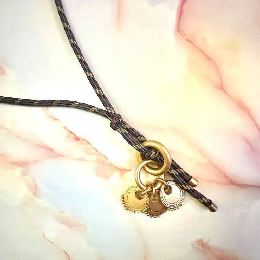 Gold tone pendant necklace on cord